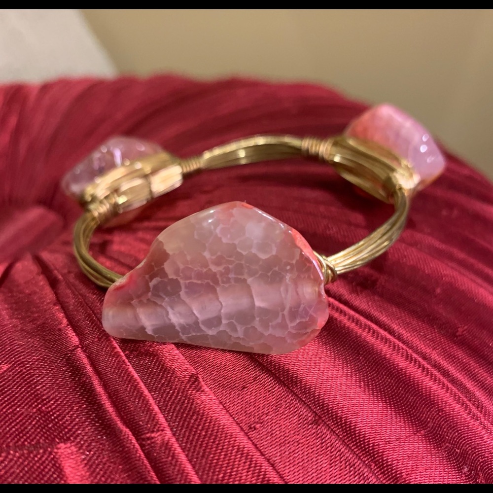 Gold bracelet with pink stones.